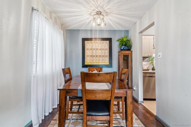 7995 E Mississippi Ave Unit C11, Denver, CO 80247 - dining room featuring an inviting chandelier and baseboards