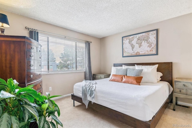 7995 E Mississippi Ave Unit C11, Denver, CO 80247 - bedroom featuring baseboards, a textured ceiling, and light colored carpet