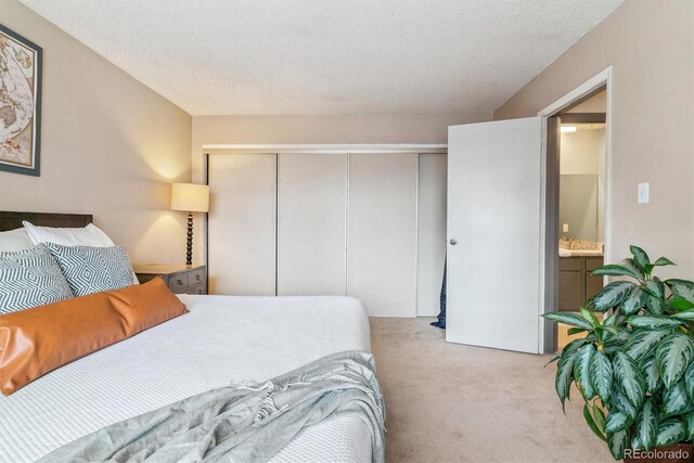 7995 E Mississippi Ave Unit C11, Denver, CO 80247 - carpeted bedroom featuring a closet and a textured ceiling