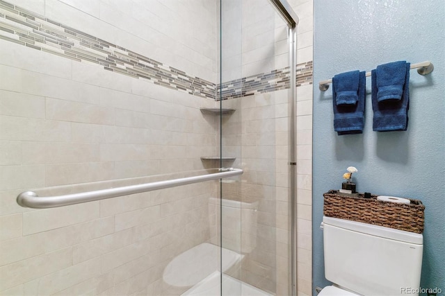 7995 E Mississippi Ave Unit C11, Denver, CO 80247 - full bathroom featuring a textured wall, toilet, and a stall shower