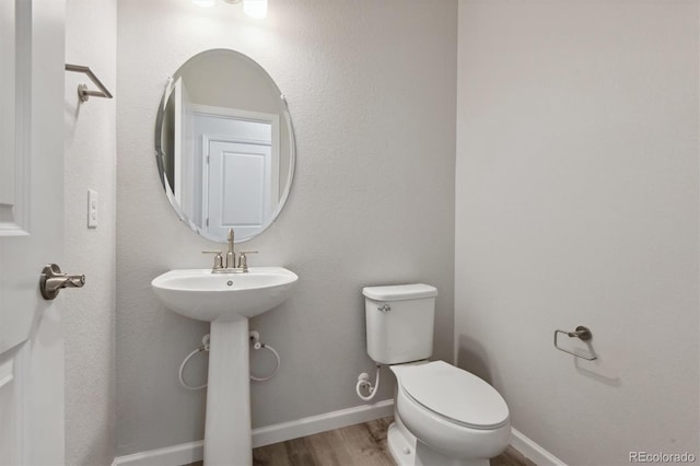 457 Interlocken Blvd Unit 101, Broomfield, CO 80021 - half bathroom with wood finished floors, toilet, and baseboards