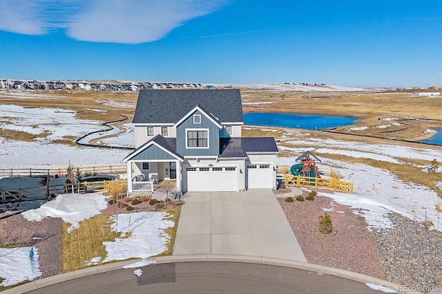 view of front of house featuring a garage and a water view