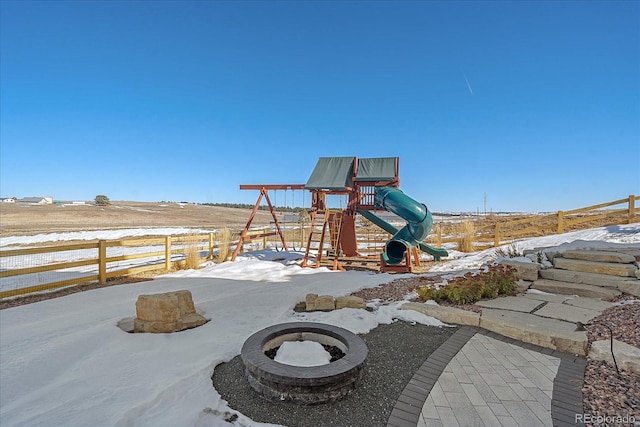 exterior space with a playground and an outdoor fire pit