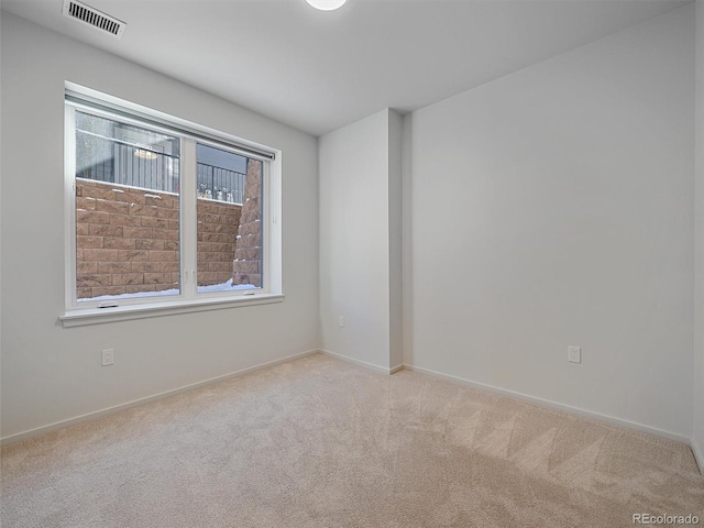 unfurnished room with light colored carpet