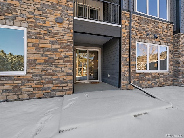 entrance to property featuring a balcony and a patio