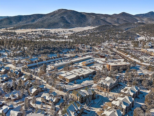 snowy aerial view with a mountain view