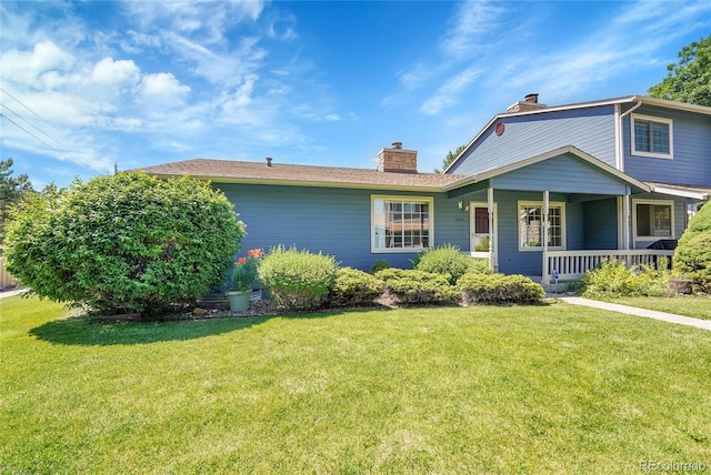 10116 Quivas St, Thornton, CO 80260 - view of front of home featuring a chimney, a front lawn, and covered porch