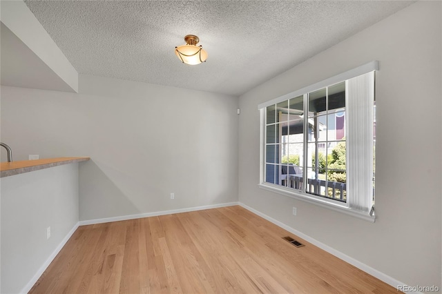 10116 Quivas St, Thornton, CO 80260 - unfurnished dining area featuring a textured ceiling and wood finished floors