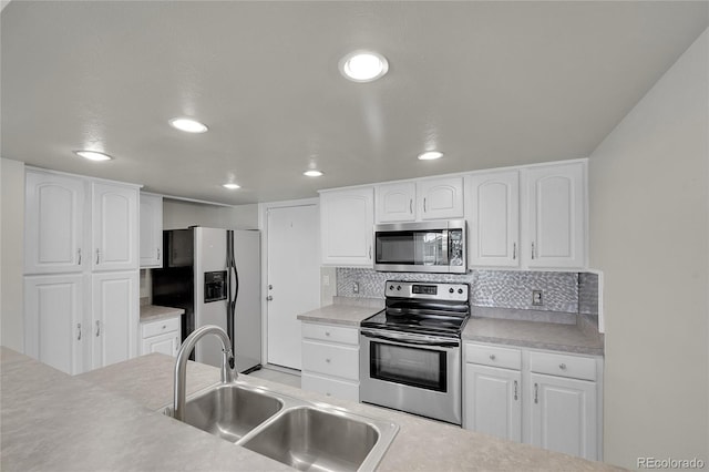 10116 Quivas St, Thornton, CO 80260 - kitchen with appliances with stainless steel finishes, recessed lighting, backsplash, and white cabinets