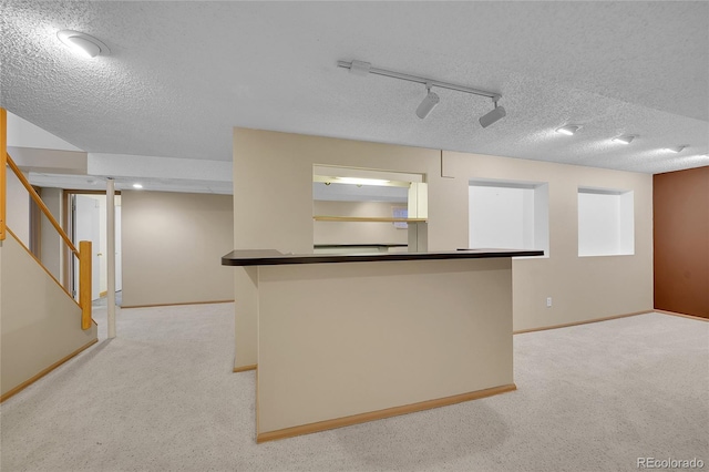 10116 Quivas St, Thornton, CO 80260 - kitchen with a textured ceiling, dark countertops, and light carpet