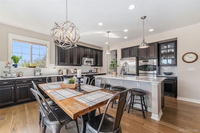 dining space with a chandelier and light hardwood / wood-style flooring