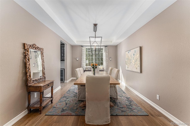 dining area featuring wood-type flooring and beverage cooler