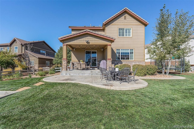 rear view of property with a patio area and a lawn