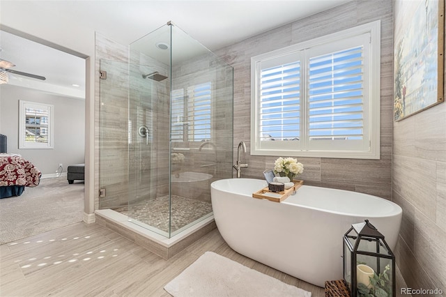 bathroom with independent shower and bath, tile walls, and tile patterned floors