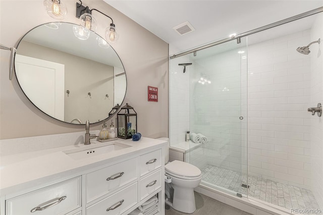 bathroom featuring vanity, toilet, and an enclosed shower