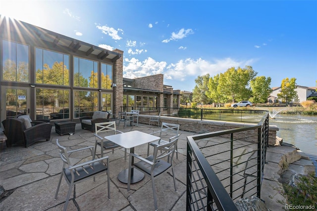 view of patio / terrace with an outdoor living space and a water view