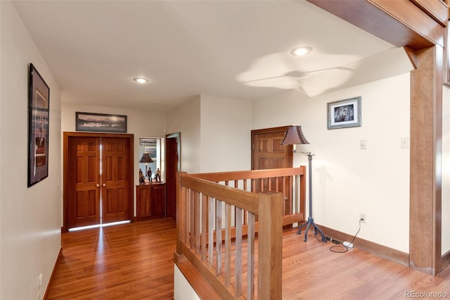 corridor with hardwood / wood-style flooring