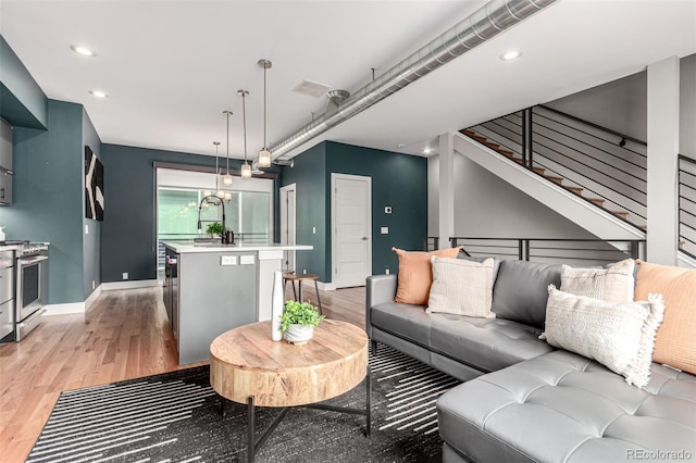 4922 Lowell Blvd Unit 2, Denver, CO 80221 - living room featuring light wood-style flooring, baseboards, recessed lighting, and stairs