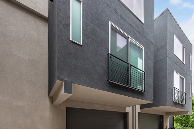 4922 Lowell Blvd Unit 2, Denver, CO 80221 - view of side of home featuring an attached garage and stucco siding