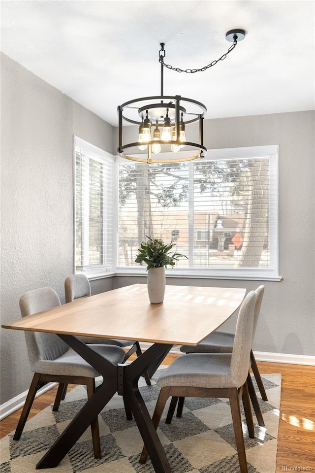 dining room featuring hardwood / wood-style flooring and a chandelier