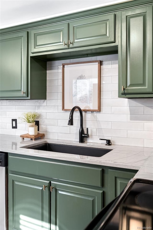 kitchen with sink, backsplash, and green cabinetry