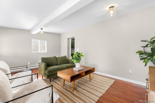 living room featuring hardwood / wood-style flooring, a baseboard heating unit, and beamed ceiling