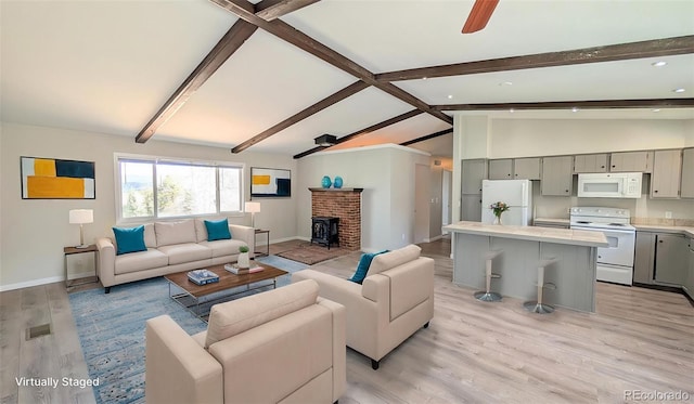720 Northwoods Dr W, Woodland Park, CO 80863 - living room featuring light wood finished floors, recessed lighting, baseboards, a ceiling fan, and vaulted ceiling with beams