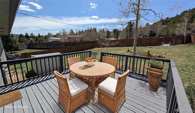 720 Northwoods Dr W, Woodland Park, CO 80863 - deck with a yard, outdoor dining area, and a fenced backyard