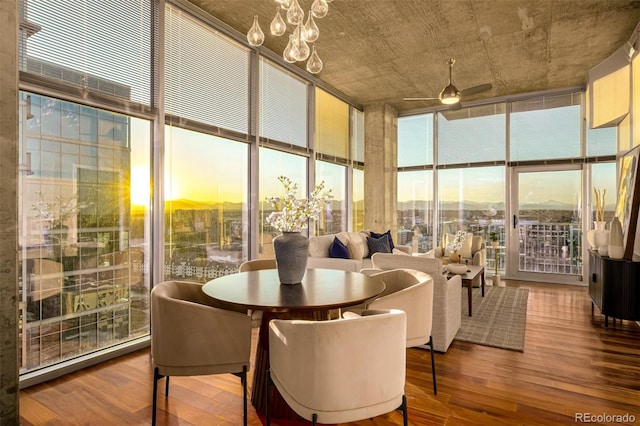 interior space with ceiling fan with notable chandelier