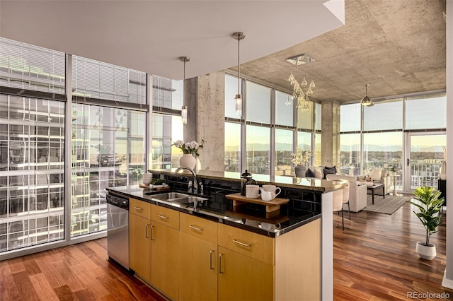 kitchen with a wall of windows, dark countertops, a sink, and a city view