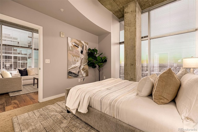 bedroom featuring wood finished floors and baseboards