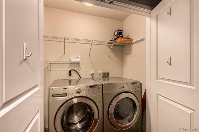 clothes washing area with laundry area and washing machine and clothes dryer