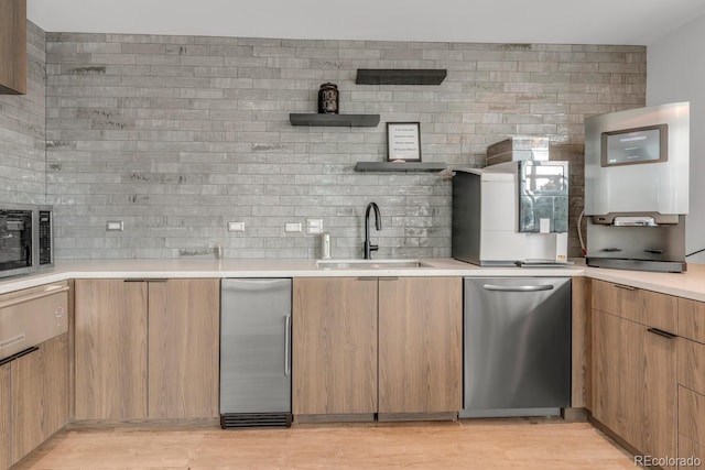 kitchen with a sink, stainless steel appliances, light countertops, open shelves, and backsplash