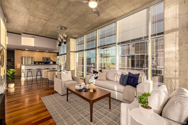 1700 Bassett St Unit 2117, Denver, CO 80202 - living room with wood finished floors, ceiling fan, a wall of windows, and a chandelier
