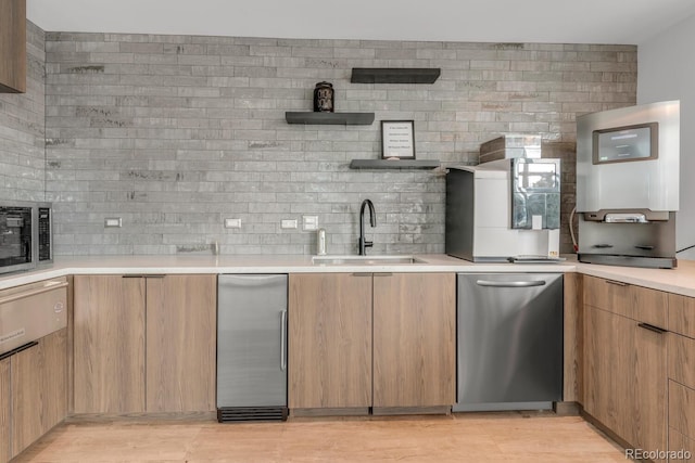 1700 Bassett St Unit 2117, Denver, CO 80202 - kitchen featuring a sink, open shelves, appliances with stainless steel finishes, light countertops, and light wood-style flooring