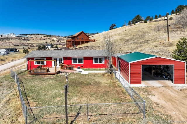 200 Silver St, Cripple Creek, CO 80813 - rear view of house with a wooden deck, a garage, and an outbuilding
