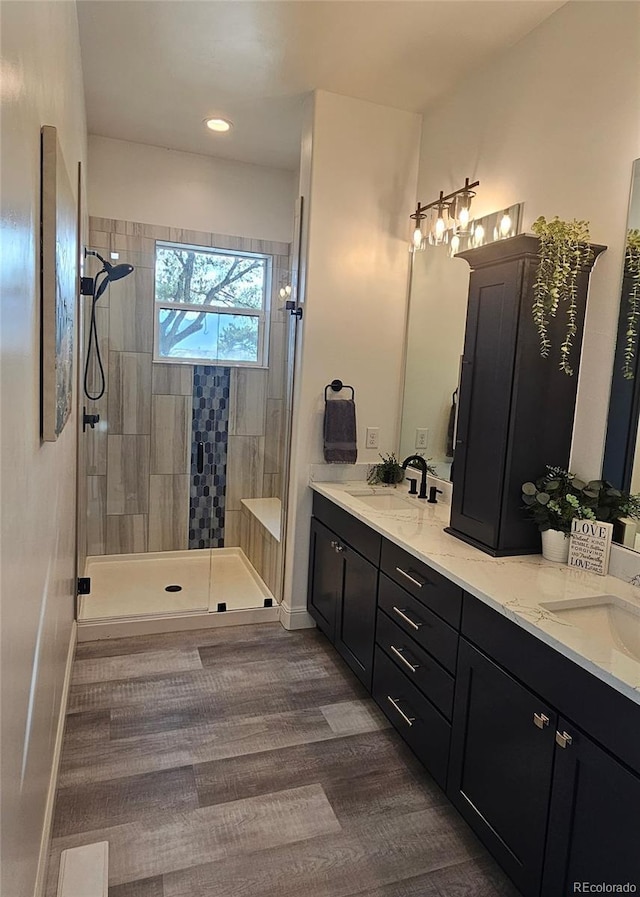 29918 Teal Run, Buena Vista, CO 81211 - bathroom featuring double vanity, walk in shower, wood finished floors, baseboards, and recessed lighting