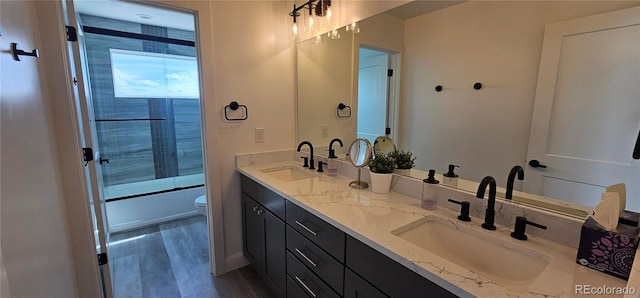 29918 Teal Run, Buena Vista, CO 81211 - full bath featuring double vanity, toilet, bath / shower combo with glass door, and wood finished floors