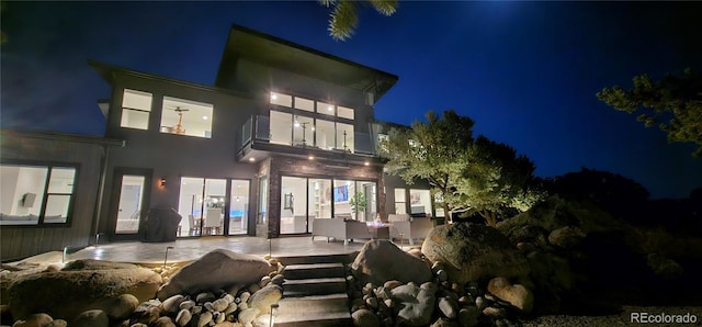 29918 Teal Run, Buena Vista, CO 81211 - back of house at twilight featuring a patio area and stucco siding