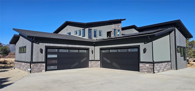29918 Teal Run, Buena Vista, CO 81211 - view of front of home featuring stone siding, concrete driveway, and a garage
