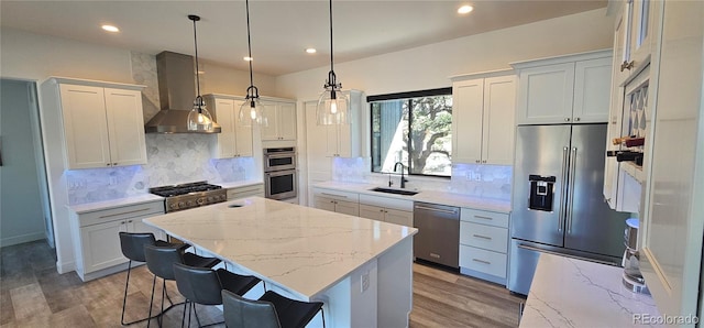 29918 Teal Run, Buena Vista, CO 81211 - kitchen featuring appliances with stainless steel finishes, wall chimney exhaust hood, a sink, a center island, and light stone counters