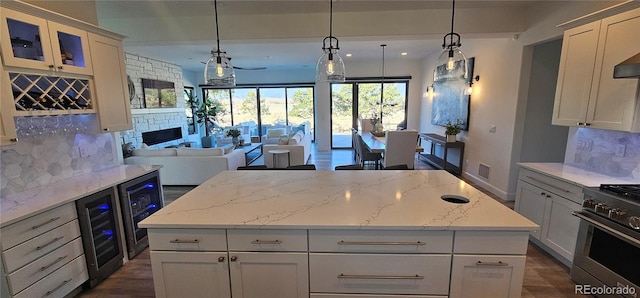 29918 Teal Run, Buena Vista, CO 81211 - kitchen featuring decorative backsplash, wine cooler, high end stove, a kitchen island, and open floor plan
