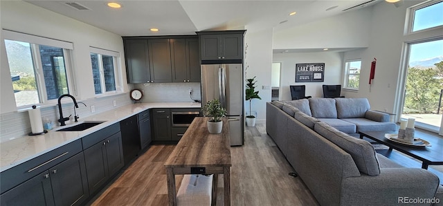 29918 Teal Run, Buena Vista, CO 81211 - kitchen featuring a sink, freestanding refrigerator, open floor plan, recessed lighting, and decorative backsplash