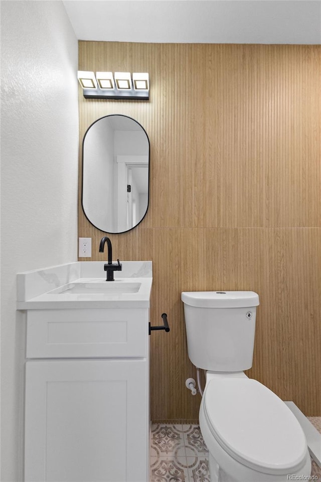 bathroom featuring toilet and vanity