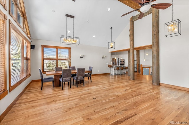 dining area featuring baseboards, light wood-style floors, ceiling fan, and high vaulted ceiling