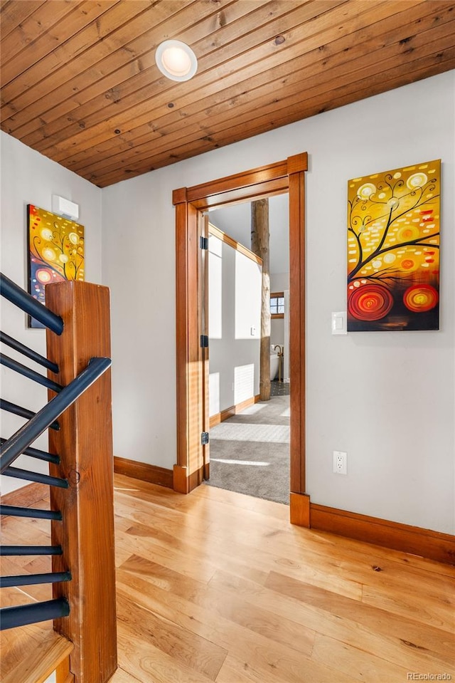 interior space featuring wood finished floors, wood ceiling, baseboards, and visible vents