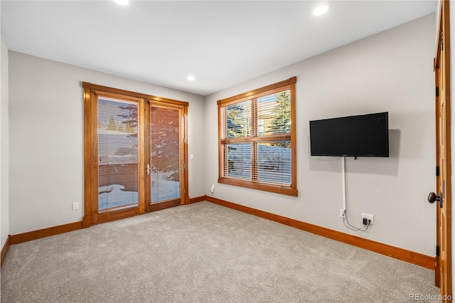 unfurnished living room featuring recessed lighting, baseboards, and carpet