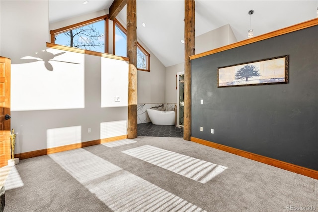 unfurnished bedroom with baseboards, carpet floors, high vaulted ceiling, and beam ceiling