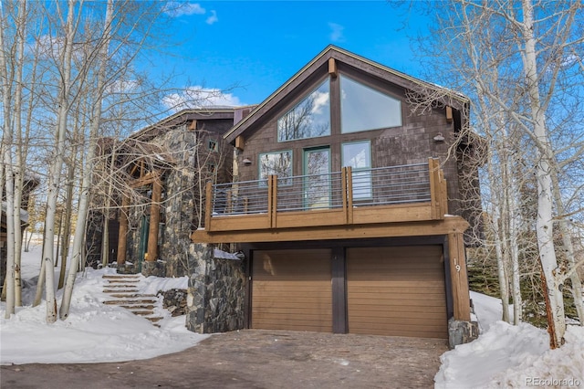 chalet / cabin featuring driveway and an attached garage