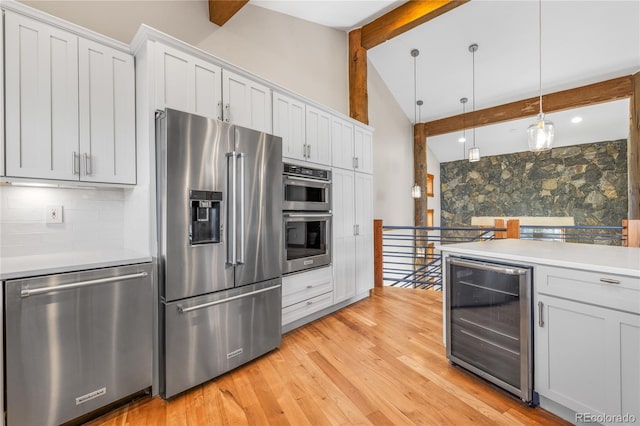 kitchen featuring beamed ceiling, light wood-style flooring, backsplash, stainless steel appliances, and wine cooler